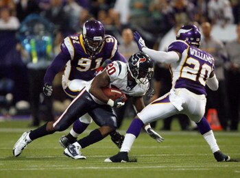MINNEAPOLIS - NOVEMBER 02:  Steve Slaton #20 of the Houston Texans runs after a catch as he is met  by Madieu Williams #20 and Ray Edwards #91 of the Minnesota Vikings during the fourth quarter at the Hubert H. Humphrey Metrodome on November 2, 2008 in Mi