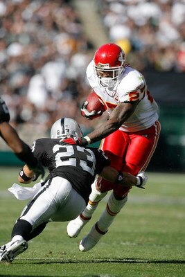 OAKLAND - October 21:  Running back Larry Johnson #27 of the Kansas City Chiefs is tackled by defensive back Chris Carr #23 of the Oakland Raiders at McAfee Coliseum October 21, 2007 in Oakland, California. California. Kansas City won 12-10.  (Photo by Gr