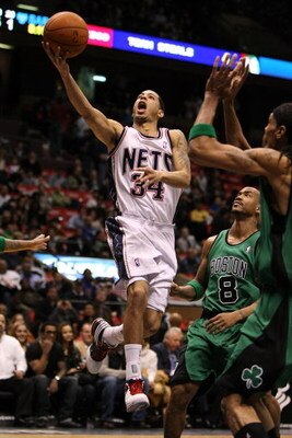 EAST RUTHERFORD, NJ - MARCH 04:  Devin Harris #34 of the New Jersey Nets shoots the ball against Stephon Marbury #8 of the Boston Celtics during their game on March 4, 2009 at The Izod Center in East Rutherford, New Jersey.  NOTE TO USER: User expressly a