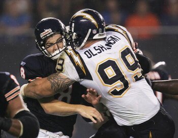 CHICAGO - AUGUST 18:   Igor Olshansky #99 of the San Diego Chargers hits Rex Grossman #8 of the Chicago Bears after a pass during a game on August 18, 2006 at Soldier Field in Chicago, Illinois.  (Photo by Jonathan Daniel/Getty Images)