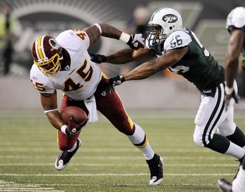 EAST RUTHERFORD, NJ - AUGUST 16:  Vernon Gholston #56 of the New York Jets  takes down Mike Sellers #45 of the Washington Redskins in a pre-season NFL game at Giants Stadium, August 16, 2008 in East Rutherford, New Jersey.  (Photo by Jeff Zelevansky/Getty