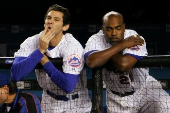 NEW YORK - SEPTEMBER 28: Shawn Green #20 and Carlos Delgado #21 of the New York Mets watch on from the dugout in the bottom of the nineth inning against the Florida Marlins during the MLB game at Shea Stadium on September 28, 2007 in the Flushing neighbor