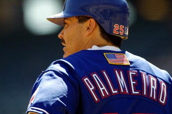 26 Sep 2001:  Rafael Palmeiro #25 of the Texas Rangers looks on during the game against the Seattle Mariners at The Ballpark in Arlington, Texas. Major League Baseball is currently wearing the American flag on the back of the uniform honoring the victims 
