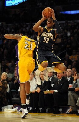 LOS ANGELES, CA - JANUARY 09:  Danny Granger #33 of the Indiana Pacers is fouled as he attempts a three pointer by Josh Powell #21 of the Los Angeles Lakers during the first half at the Staples Center on January 9, 2009 in Los Angeles, California.   NOTE 