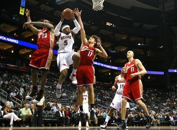 ATLANTA - MAY 11:  Josh Smith #5 of the Atlanta Hawks drives to the basket against LeBron James #23 and Anderson Varejao #17 of the Cleveland Cavaliers during Game Four of the Eastern Conference Semifinals during the 2009 NBA Playoffs at Philips Arena on 