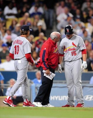 LOS ANGELES, CA - AUGUST 17: Matt Holliday #15 is checked by a trainer and Manager Tony La Russa #10 of the St. Louis Cardinals after Holliday was hit in the leg by a ball in the eighth inning against the Los Angeles Dodgers on August 17, 2009 in Los Ange