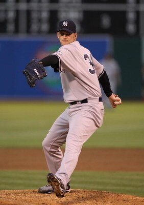 OAKLAND, CA - AUGUST 17:  A.J. Burnett #34 of the New York Yankees delivers a pitch in the third inning against the Oakland Athletics during the Major League Baseball game at the Oakland Coliseum on August 17, 2009 in Oakland, California. (Photo by Jed Ja