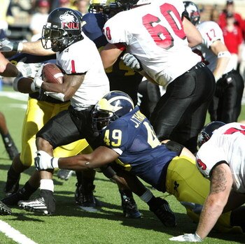 ANN ARBOR - SEPTEMBER 3:  John Thompson #49 of Michigan tackles Garrett Wolfe #1 of Northern Illinois at Michigan Stadium on September 3, 2005 in Ann Arbor, Michigan.  Michigan won the game, 33-17. (Photo by Tom Pidgeon/Getty Images)