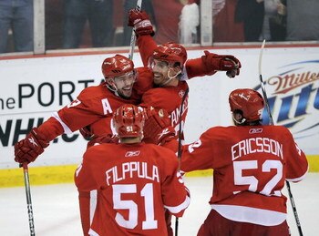 DETROIT - MAY 14:  Mikael Samuelsson #37 of the Detroit Red Wings celebrates his second period goal with Pavel Datsyuk #13, Valtteri Filppula #51 and Jonathan Ericsson #52 while playing the Anaheim Ducks in Game Seven of the Western Conference Semifinals 