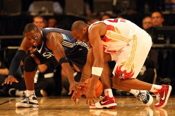 PHOENIX - FEBRUARY 15:  Dwyane Wade #3 of the Eastern Conference and Kobe Bryant #24 of the Western Conference go after a loose ball during the 58th NBA All-Star Game, part of 2009 NBA All-Star Weekend at US Airways Center on February 15, 2009 in Phoenix,
