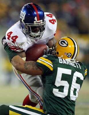 GREEN BAY, WI - JANUARY 20:  Running back Ahmad Bradshaw #44 of the New York Giants runs the ball and is tackled by Nick Barnett #56 of the Green Bay Packers during the NFC championship game on January 20, 2008 at Lambeau Field in Green Bay, Wisconsin.  (