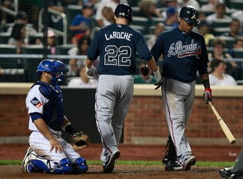 NEW YORK - AUGUST 19:  Adam LaRoche #22 is congratulated at home plate by Yunel Escobar #19 of the Atlanta Braves after LaRoche hit a solo home run against the New York Mets during the game on August 19, 2009 at Citi Field in the Flushing neighborhood of 
