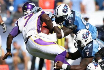MINNEAPOLIS - DECEMBER 28:   Quarterback Tarvaris Jackson #7 of the Minnesota Vikings is hit by Bryan Kehl #53 of the New York Giants on December 28, 2008 at the Hubert H. Humphrey Metrodome in Minneapolis, Minnesota. (Photo by Elsa/Getty Images)