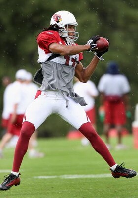 FLAGSTAFF, AZ - JULY 31: Wide receiver Larry Fitzgerald #11 of the Arizona Cardinals makes a leaping reception during the evening team training camp at Northern Arizona University on July 31, 2009 in Flagstaff, Arizona. (Photo by Christian Petersen/Getty 