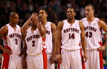 BOSTON - DECEMBER 07:  (L-R) Juan Dixon #3,Darrick Martin #2,Jamario Moon #33,Joey Graham #14 and Kris Humphries #43 of the Toronto Raptors walk on to the court after a time out in the fourth quarter against the Boston Celtics on December 7, 2007 at the T