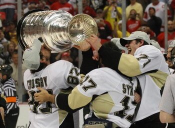 DETROIT - JUNE 12: (L-R) Sideny Crosby #87, Petr Sykora #17 and Evgeni Malkin #71 of the Pittsburgh Penguins hold  the Stanley Cup following the Penguins victory over the Detroit Red Wings in Game Seven of the 2009 NHL Stanley Cup Finals at Joe Louis Aren