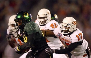 SAN DIEGO, CA - DECEMBER 30:   Runningback Jeremiah Johnson #24 of the University of Oregon Ducks runs back a kick-return for a touchdown against the Oklahoma State University Cowboys during the Pacific Life Holiday Bowl at Qualcomm Stadium on December 30
