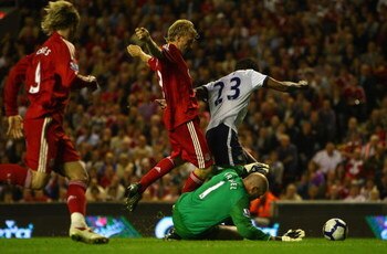 LIVERPOOL, ENGLAND - AUGUST 24:  Brad Friedel of Aston Villa dives to make a save at the feet of Dirk Kuyt of Liverpool during the Barclays Premier League match between Liverpool and Aston Villa at Anfield on August 24, 2009 in Liverpool, England.  (Photo