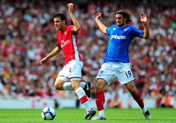 LONDON, ENGLAND - AUGUST 22:  Cesc Fabregas of Arsenal is challenged by Niko Kranjcar of Portsmouth during the Barclays Premier League match between Arsenal and Portsmouth at the Emirates Stadium on August 22, 2009 in London, England.  (Photo by Mike Hewi