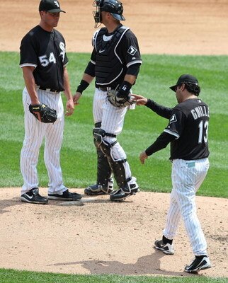 CHICAGO - JUNE 08: Manager Ozzie Guillen #13 of the Chicago White Sox calls for a relief pitcher as he removes starting pitcher Clayton Richard #54 from a game against the Detroit Tigers as A.J. Pierzynski #12 looks to the bullpen on June 8, 2009 at U.S. 