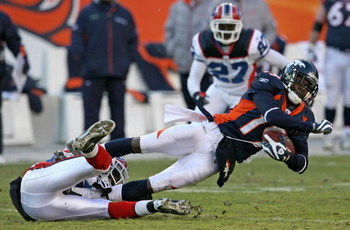 DENVER - DECEMBER 21: Wide receiver Eddie Royal #19 of the Denver Broncos makes a reception as cornerback Leodis McKelvin #28 of the Buffalo Bills makes the tackle during NFL action at Invesco Field at Mile High on December 21, 2008 in Denver, Colorado.