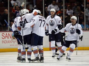 ANAHEIM, CA - MARCH 27:  Andrew Cogliano #13 of the Edmonton Oilers (R) looks to celebrate a goal by teammate Fernando Pisani #34 with teammates Tom Gilbert #77 and Denis Grebeshkov #37 in the first period against the Anaheim Ducks during the NHL game at 