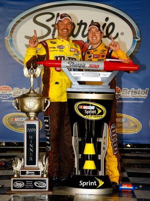 BRISTOL, TN - AUGUST 22: Kyle Busch (R), driver of the #18 M&M's Toyota, poses with crew chief Steve Addington in victory lane after winning the NASCAR Sprint Cup Series Sharpie 500 at Bristol Motor Speedway on August 22, 2009 in Bristol, Tennessee.  (Pho