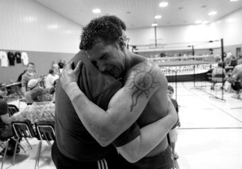 ELDON - JULY 8: Mike (right) and hugs his father Teddy DiBiase after winning his first professional fight for the World League Wrestling on July 8, 2006 in Eldon, Missouri. They trained at the Harley Race Wrestling Academy. Harley Race's legendary wrestli
