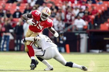 SAN FRANCISCO - AUGUST 22:   San Francisco 49ers tight end Vernon Davis #85 tries to break tackle by Oakland Raiders cornerback Chris Johnson #37 during the 1st quarter as the San Francisco 49ers host the Oakland Raiders at Candlestick Park August 22, 200