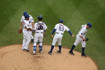 NEW YORK - AUGUST 23:  Oliver Perez #46 of the New York Mets is taken out of the game in the first inning by Manager Jerry Manuel after giving up 6 runs to  the Philadelphia Phillies during their game on August 23, 2009 at Citi Field in the Flushing neigh
