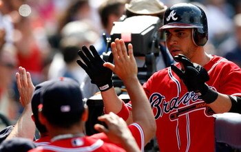 ATLANTA - AUGUST 23:  Omar Infante #4 of the Atlanta Braves celebrates in the dugout after scoring in the bottom of the eighth inning against the Florida Marlins on August 23, 2009 at Turner Field in Atlanta, Georgia.  (Photo by Kevin C. Cox/Getty Images)