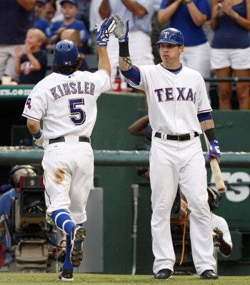 ARLINGTON, TX - JULY 22:  Ian Kinsler #5 of the Texas Rangers celebrates his home run with teammate Josh Hamilton #32, tying the game 1-1 during the third inning against the Boston Red Sox at Rangers Ballpark July 22, 2009 in Arlington, Texas.  (Photo by 