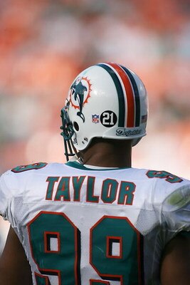 MIAMI - DECEMBER 2:  Jason Taylor #99 of the Miami Dolphins displays Sean Talyors #21 on his helmet during the NFL game against the New York Jets at the Dolphin Stadium on December 2, 2007 in Miami, Florida. (Photo by Doug Benc/Getty Images)