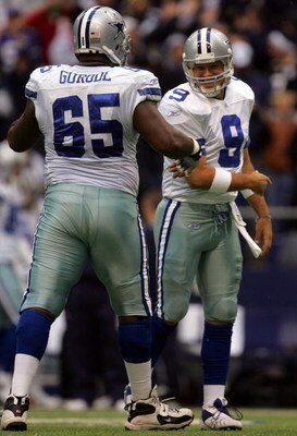 DALLAS - NOVEMBER 22:  Quarterback Tony Romo #9 of the Dallas Cowboys celebrates a touchdown with teammate Andre Gurode #65 against the New York Jets in the second quarter at Texas Stadium November 22, 2007 in Irving, Texas.  (Photo by Ronald Martinez/Get