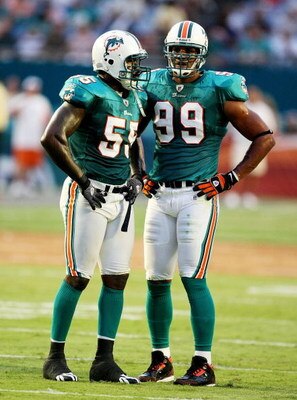 MIAMI - AUGUST 17:  Defensive end Jason Taylor #99 and linebacker Joey Porter #55 of the Miami Dolphins talk between plays against the Jacksonville Jaguars during a preseason game at Landshark Stadium on August 17, 2009 in Miami, Florida.  (Photo by Doug 