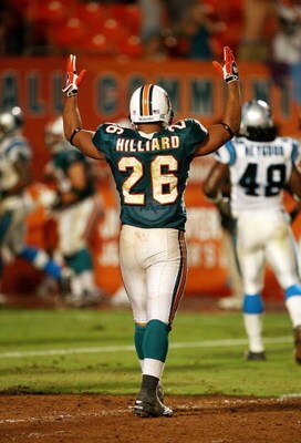 MIAMI - AUGUST 22:  Running back Lex Hilliard #26 of the Miami Dolphins celebrates after fullback Joe Kowalewski #40 scored a touchdown against the Carolina Panthers during a pre-season game at Land Shark Stadium on August 22, 2009 in Miami, Florida. The 