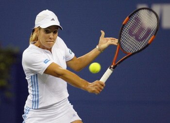 FLUSHING, NY - SEPTEMBER 5:  Justine Henin-Hardenne of Belgium returns a shot to Jennifer Capriati of the USA during the US Open at the USTA National Tennis Center, Flushing Meadows Corona Park on September 5, 2003 in Flushing, New York. (Photo by Nick La