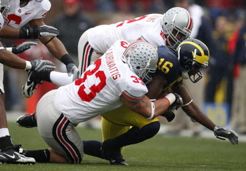 ANN ARBOR, MI - NOVEMBER 17: Adrian Arrington #16 of the Michigan Wolverines is tackled by James Laurinaitis #33 and Malcolm Jenkins #2 of the Ohio State Buckeyes on November 17, 2007 at Michigan Stadium in Ann Arbor, Michigan. Ohio State won the game 14-
