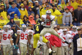 ANN ARBOR, MI - NOVEMBER 24: Safety Michael Doss #2 of the Ohio State Buckeyes intercepts the ball over wide receiver Marquise Walker #4 of the Michigan Wolverines during the Big Ten Conference football game on November 24, 2001 at Michigan Stadium in An