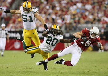 GLENDALE, AZ - AUGUST 28:  Wide receiver Jerheme Urban #85 of the Arizona Cardinals catches a pass for the first down against Atari Bigby #20 of the Green Bay Packers during the second quarter at the University of Phoenix Stadium on August 28, 2009 in Gle