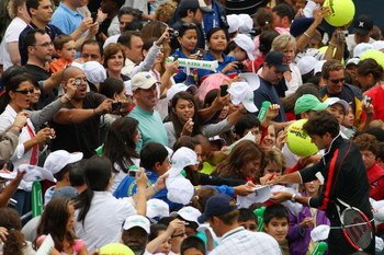 FLUSHING, NY - AUGUST 29:  Roger Federer of Switzerland signs autographs during Arthur Ashe Kid's Day at the 2009 U.S. Open at the Billie Jean King National Tennis Center on August 29, 2009 in the Flushing neighborhood of the Queens borough of New York Ci