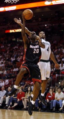 MIAMI - MARCH 9:  Guard Gary Payton #20 of the Miami Heat shoots over Guard Randy Foye #4 of the Minnesota Timberwolves at the American Airlines Arena March 9, 2007 in Miami, Florida. NOTE TO USER: User expressly acknowledges and agrees that, by downloadi