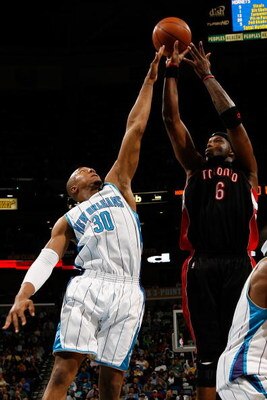 NEW ORLEANS - FEBRUARY 06:  Jermaine O'Neal #6 of the Toronto Raptors makes a shot over David West #30 of the New Orleans Hornets on February 6, 2009 in New Orleans, Louisiana. The Hornets defeated the Raptors 101-92.   NOTE TO USER: User expressly acknow