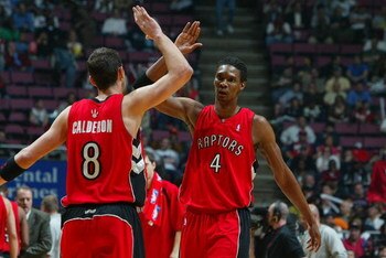 EAST RUTHERFORD, NJ - MAY 04:   Chris Bosh #4 and Jose Calderon #8 of the Toronto Raptors high five during a break in play against the New Jersey Nets in Game Six of the Eastern Conference Quarterfinals during the 2007 NBA Playoffs on May 4, 2007 at the C