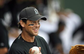 JUPITER, FL - MARCH 01: First baseman Aaron Boone #8 of the Florida Marlins tosses the ball in the duggout during a game against the Baltimore Orioles at Roger Dean Stadium in Jupiter, Florida on March 1, 2007. (Photo by Marc Serota/Getty Images) 