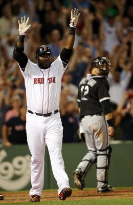 BOSTON - AUGUST 26:  David Ortiz #34 of the Boston Red Sox celebrates his solo home run at the bottom of the 9th inning to win the game as catcher A.J. Pierzynski #23 of the Chicago White Sox walks off the field on August 26, 2009 at Fenway Park in Boston