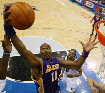 MINNEAPOLIS, MN - MAY 21:  Karl Malone #11 of the Los Angeles Lakers rebounds in the second half against the Minnesota Timberwolves in Game one of the Western Conference Finals during the 2004 NBA Playoffs on May 21, 2004 at Target Center in Minneapolis, 