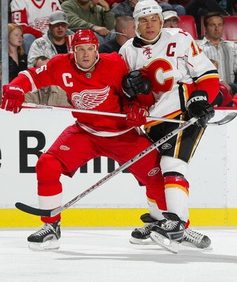 DETROIT - OCTOBER 10:  Niklas Lidstrom #5 of the Detroit Red Wings holds up Jarome Iginla #12 of the Calgary Flames in a game on October 10, 2007 at the Joe Louis Arena in Detroit, Michigan. The Red Wings defeated the Flames 4-2. (Photo by Claus Andersen/