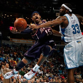 NEW ORLEANS - JANUARY 21:  Vince Carter #15 of the New Jersey Nets shoots around Melvin Ely #33 of the New Orleans Hornets on January 21, 2009 at the New Orleans Arena in New Orleans, Louisiana. The Hornets defeated the Nets 102-92.   NOTE TO USER: User e