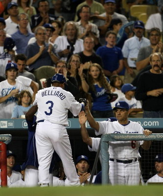 LOS ANGELES - AUGUST 31: Ronnie Belliard #3 of the Los Angeles Dodgers is greeted by manager Joe Torre as he returns to the dugout after hitting a home in run in his first at bat as a Dodger in the second inning against the Arizona Diamondbacks on August